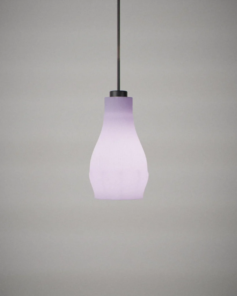 Bottle, lit, on a pale grey wall