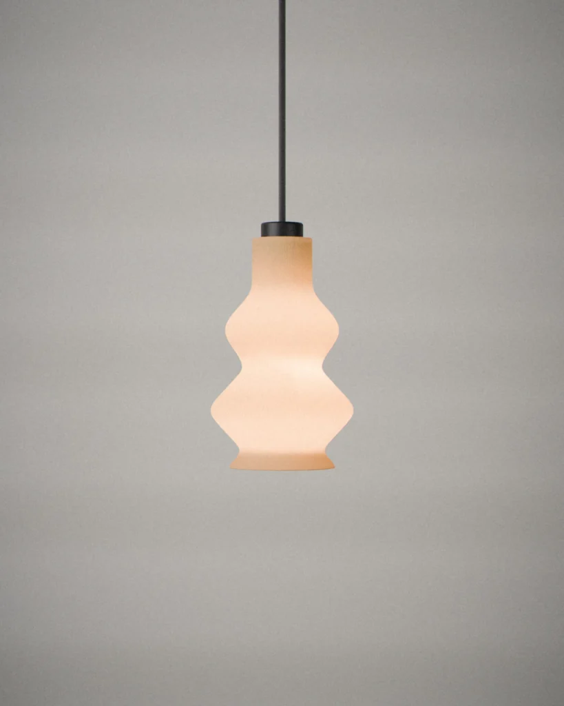 Gourd, lit, on a pale grey wall