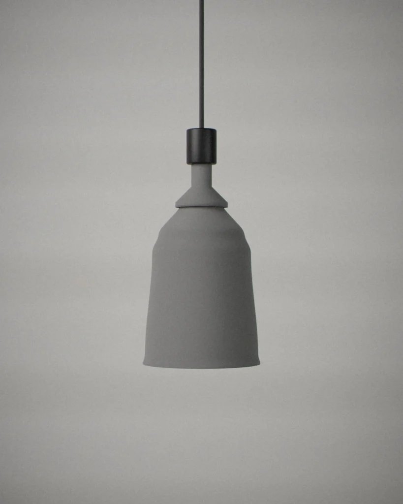 Handbell, lit, on a pale grey wall