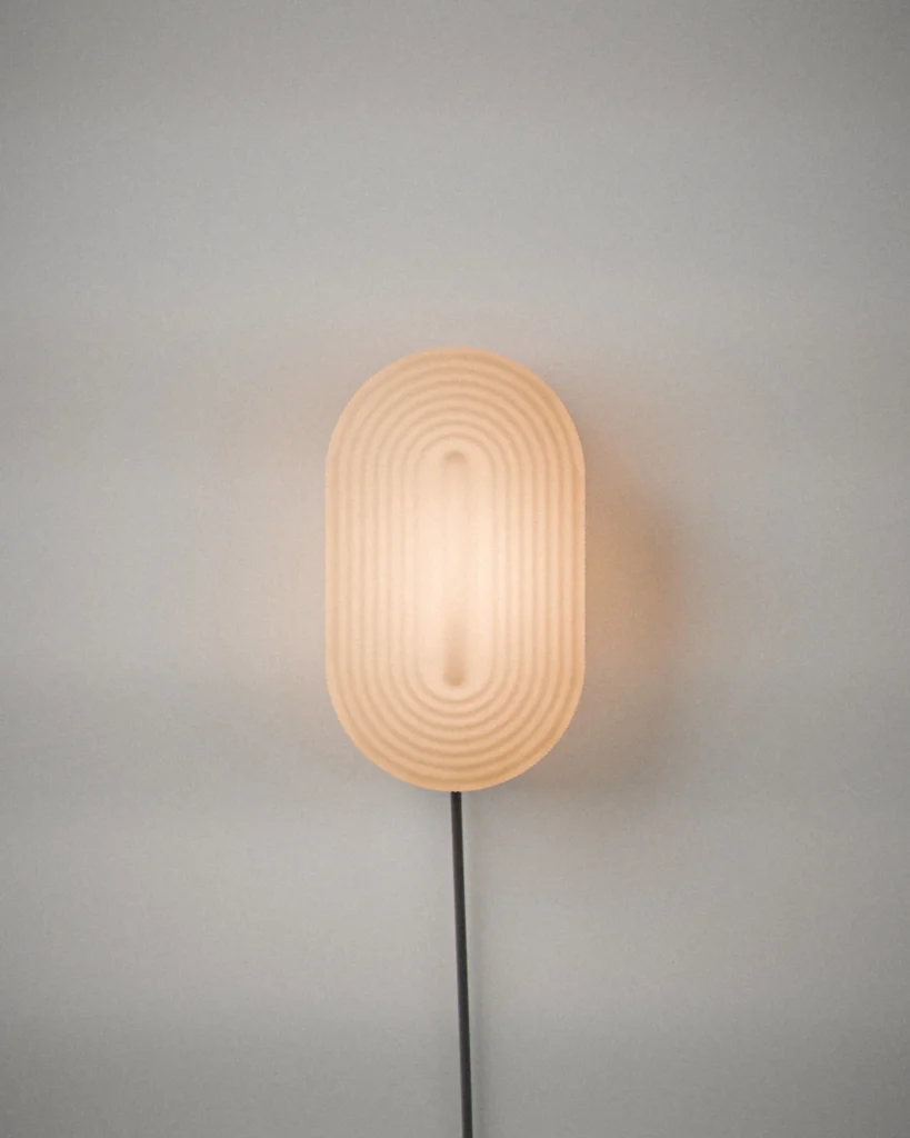 Koban, lit, on a pale grey wall