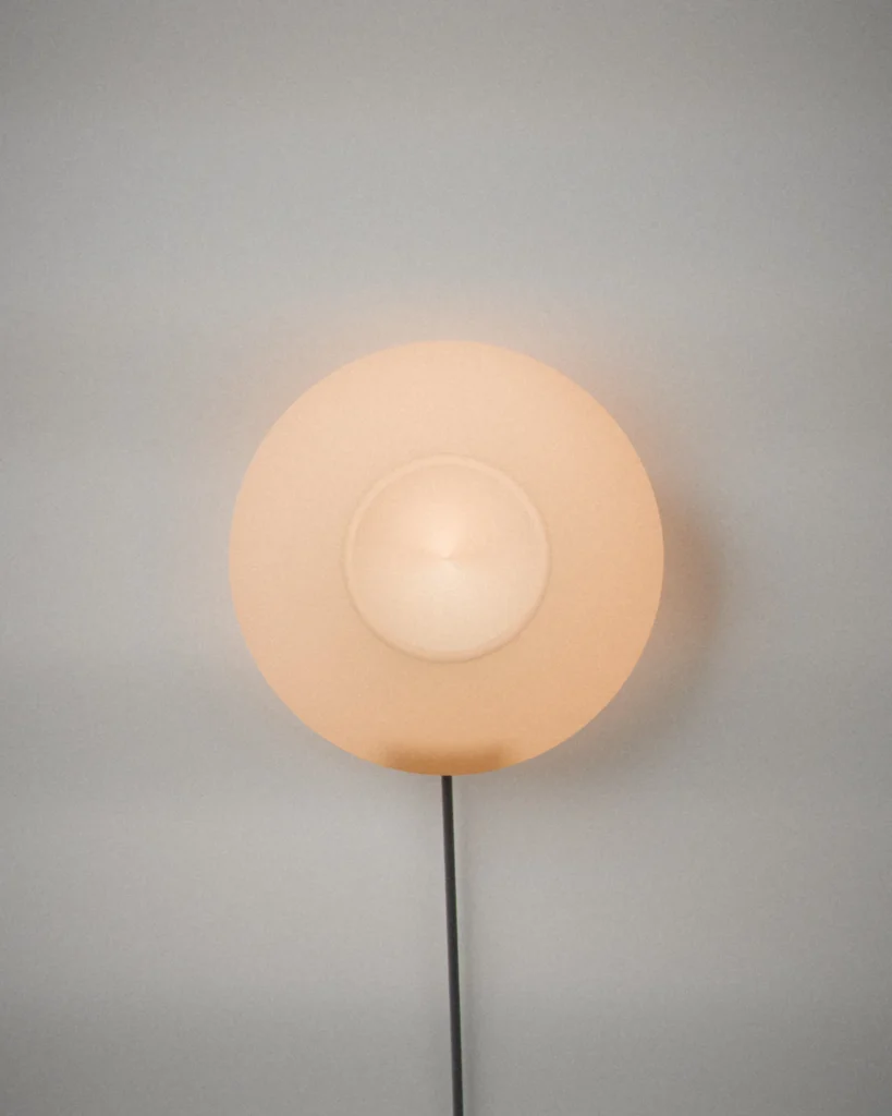 Koma Wall, lit, on a pale grey wall