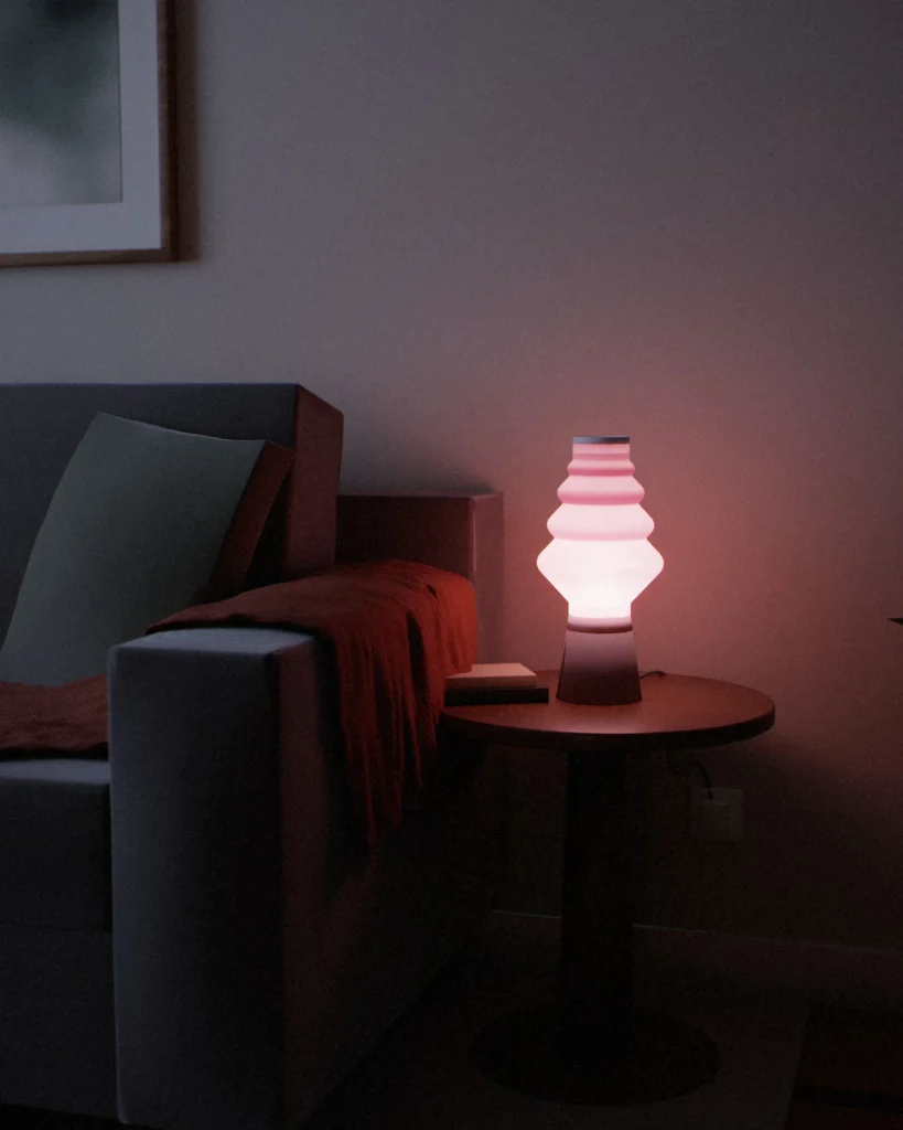 Kumo lit in a furnished room in the evening