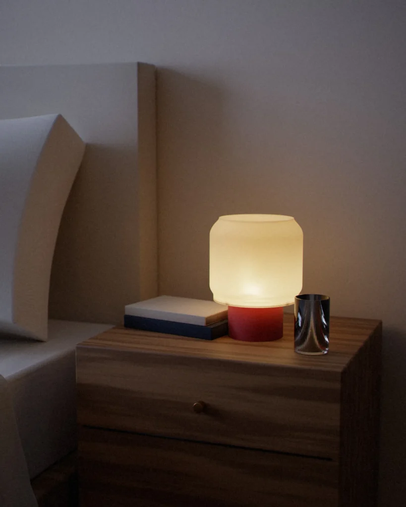 Moyō lit in a furnished room in the evening