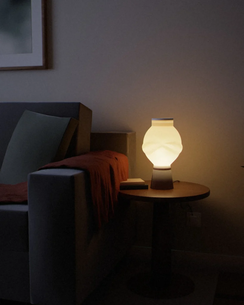 Nami lit in a furnished room in the evening
