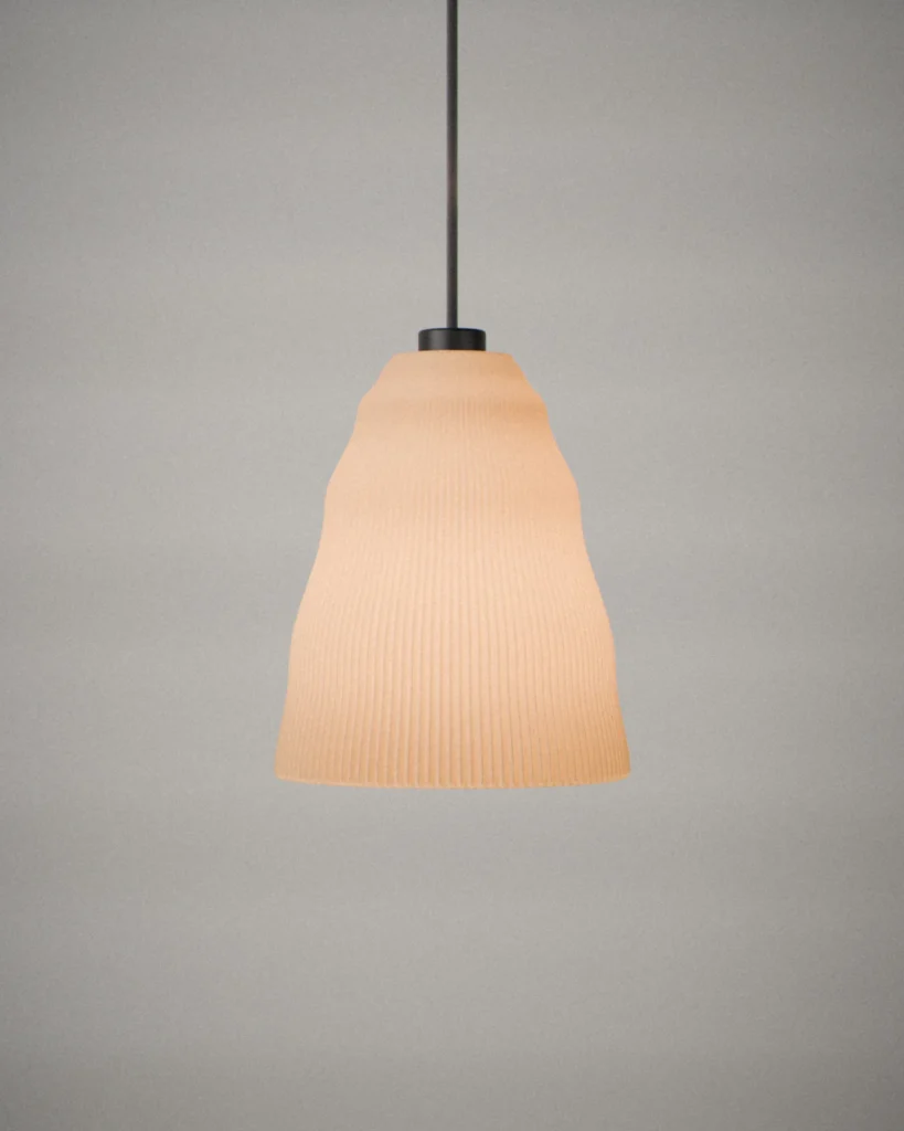 Pleat, lit, on a pale grey wall