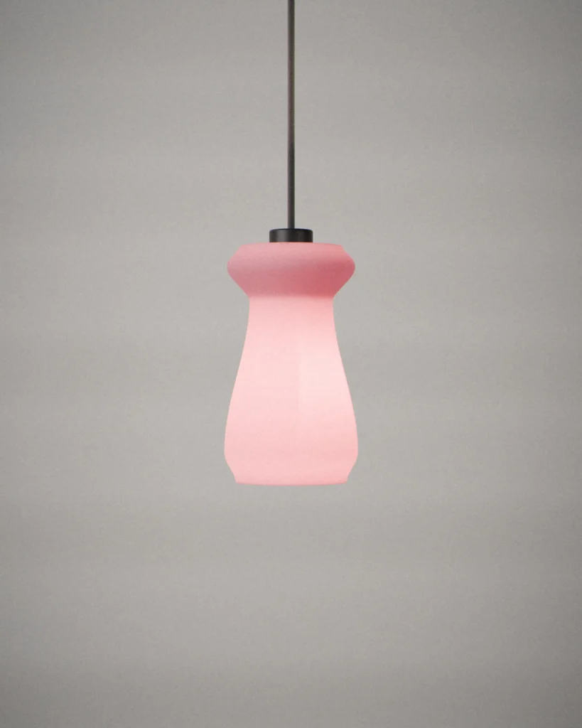 Spool, lit, on a pale grey wall