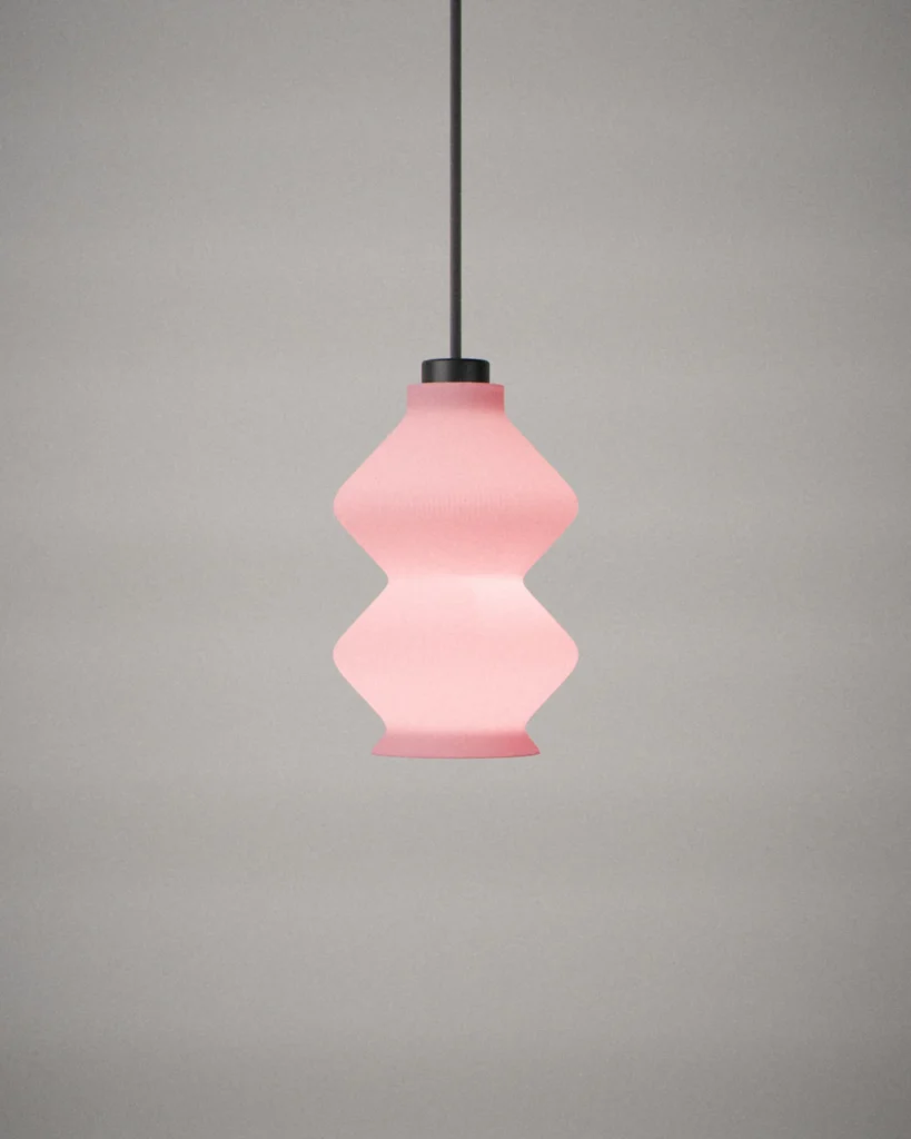 Stack, lit, on a pale grey wall