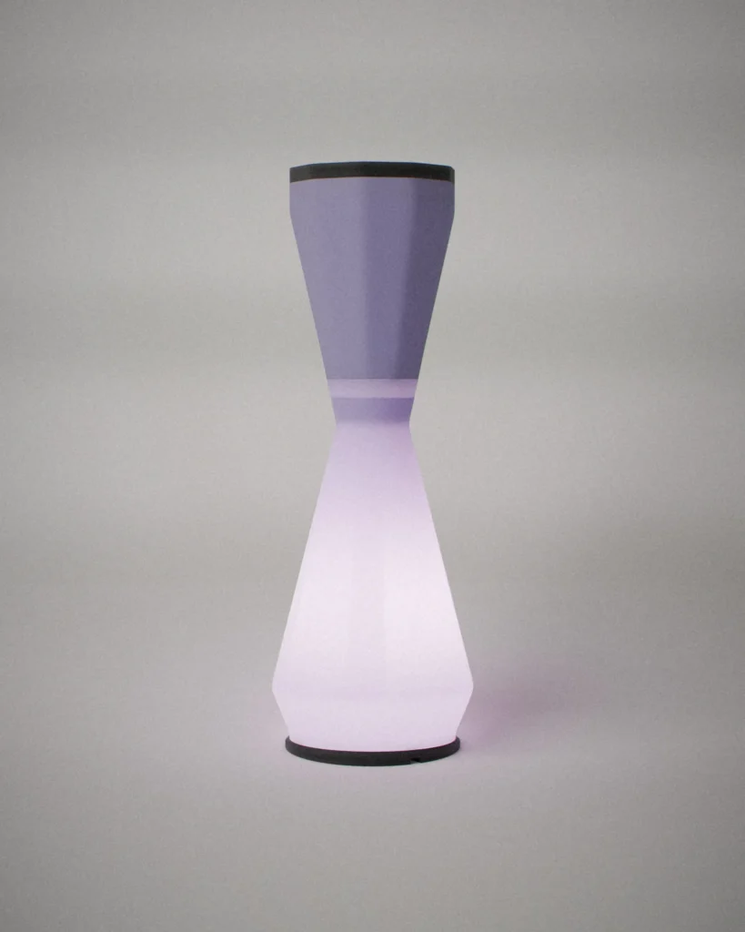 Taper, lit, on a pale grey wall