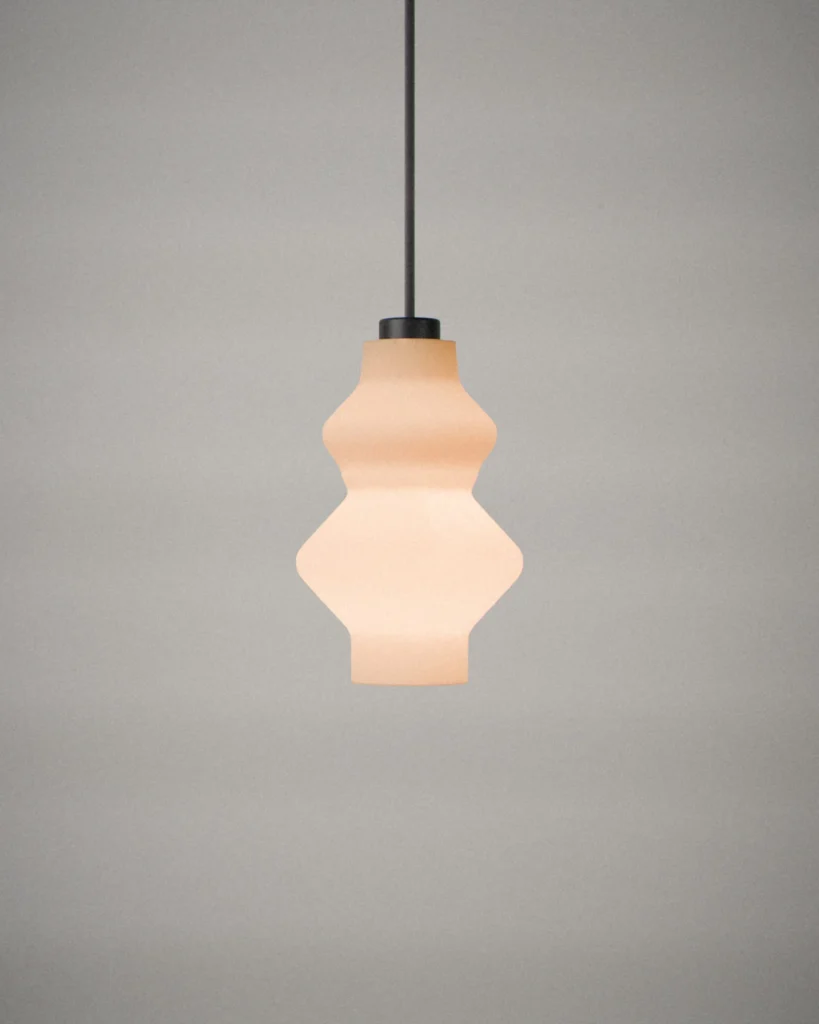 Tiers, lit, on a pale grey wall