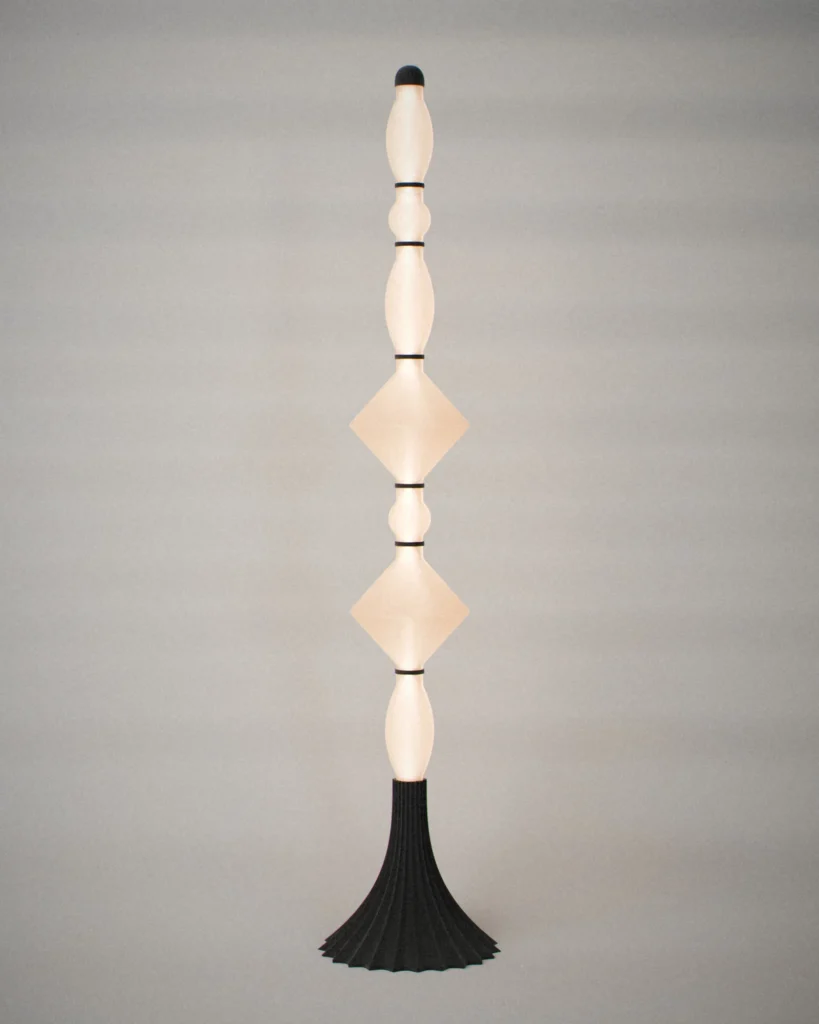 Totem, lit, on a pale grey wall