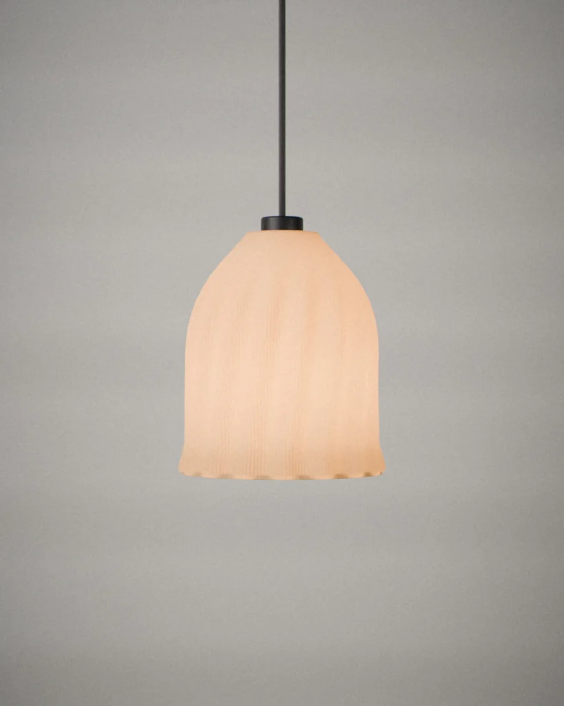 Tsurigane, lit, on a pale grey wall