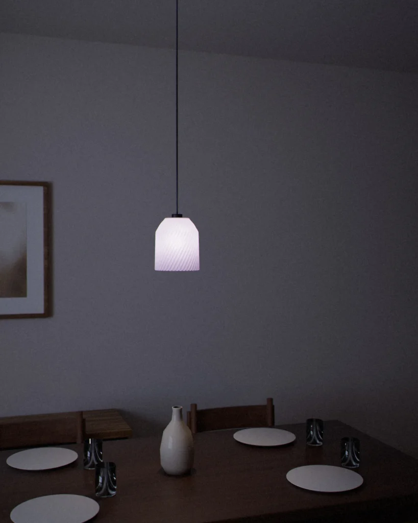 Yunomi lit in a furnished room in the evening